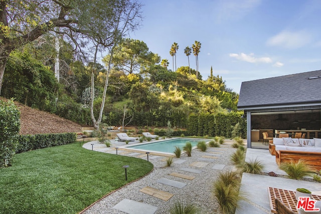 view of pool featuring a patio area, an outdoor hangout area, and a yard