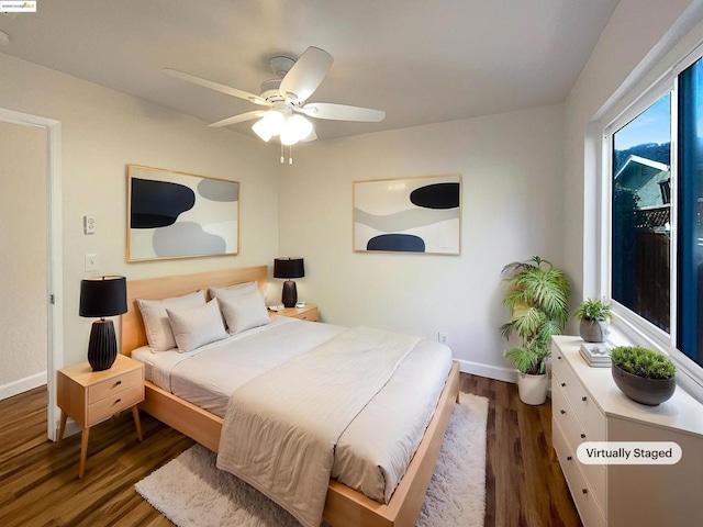 bedroom with ceiling fan and dark wood-type flooring