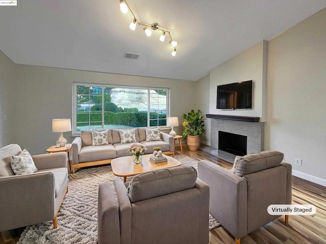 living room featuring hardwood / wood-style flooring and vaulted ceiling