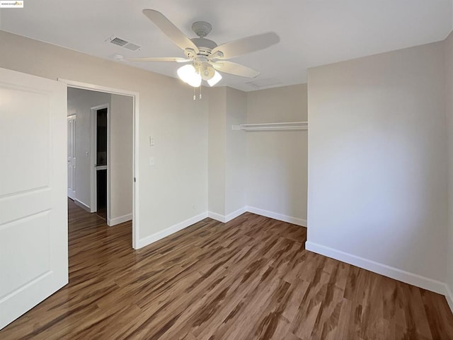 empty room featuring dark hardwood / wood-style flooring and ceiling fan