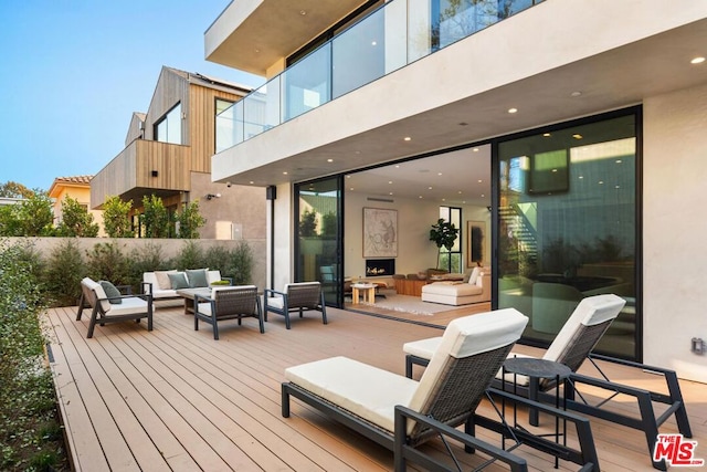 wooden terrace with an outdoor hangout area