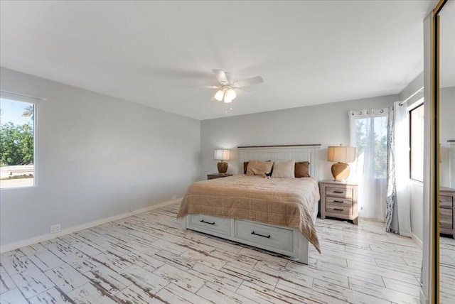 bedroom with ceiling fan and light hardwood / wood-style flooring