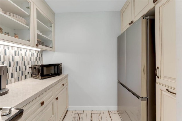 kitchen with tasteful backsplash and stainless steel refrigerator