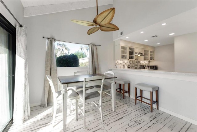 dining room featuring lofted ceiling and ceiling fan