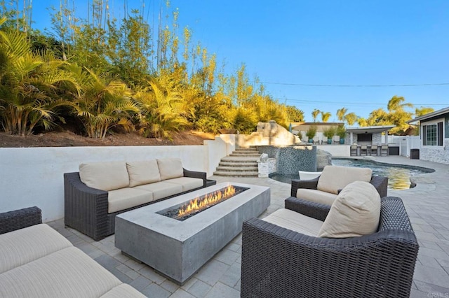 view of patio featuring an outdoor living space with a fire pit