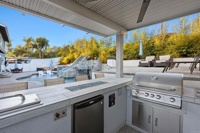 view of patio / terrace featuring ceiling fan, area for grilling, an outdoor hangout area, and a grill