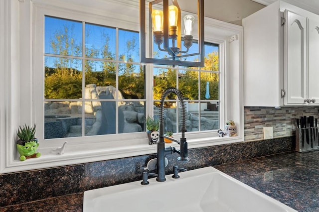 1404 E Mission Rd, Fallbrook, CA 92028 - bathroom with a sink, a chandelier, and backsplash