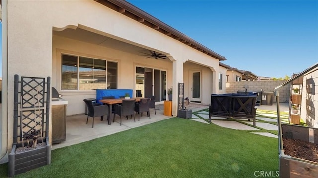 back of property featuring a patio area, a yard, and ceiling fan