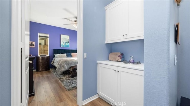 bedroom featuring light wood-type flooring and ceiling fan