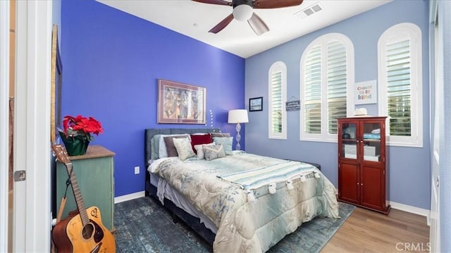 bedroom with wood-type flooring and ceiling fan