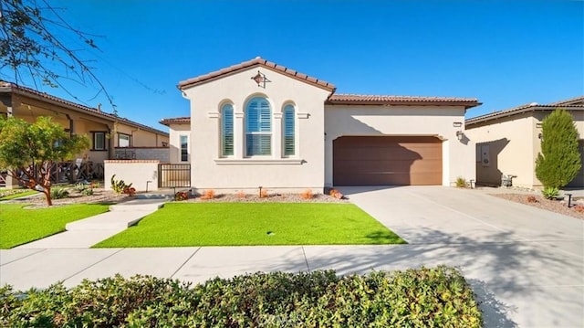 mediterranean / spanish home with a garage and a front yard