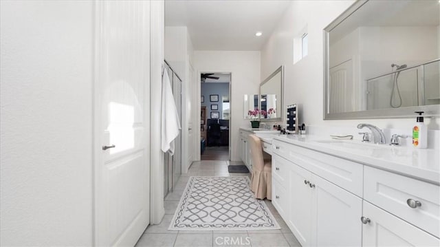 bathroom with vanity, a shower with shower door, ceiling fan, and tile patterned floors