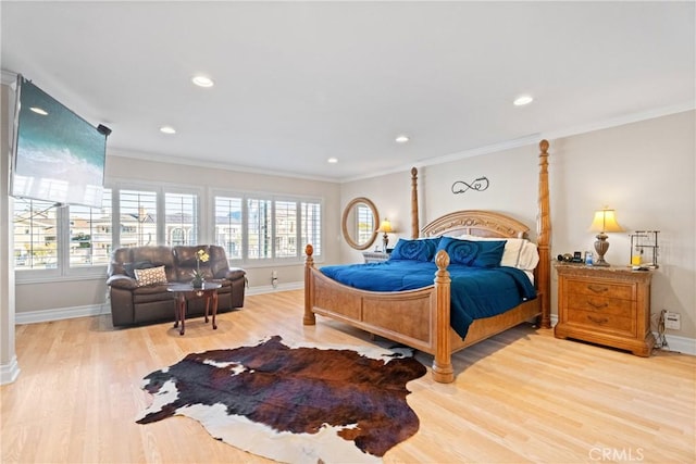 bedroom featuring ornamental molding and light hardwood / wood-style flooring