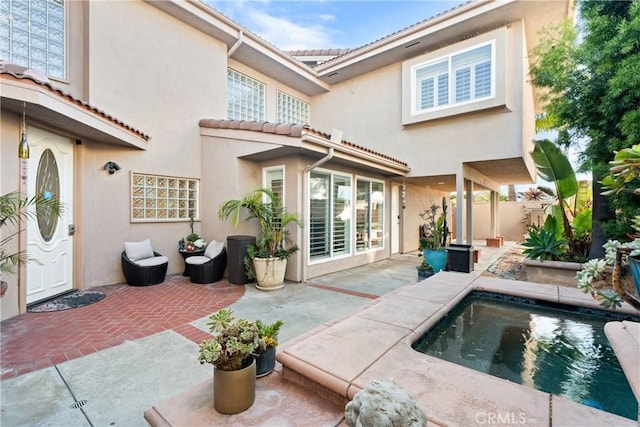 rear view of house with a swimming pool and a patio area