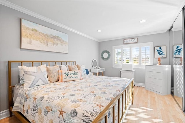 bedroom with ornamental molding and light hardwood / wood-style floors