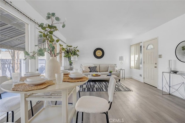 dining space with light wood-type flooring and breakfast area