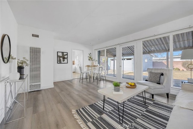 living room with light hardwood / wood-style flooring and french doors