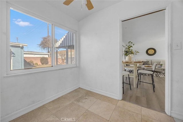 tiled empty room with ceiling fan