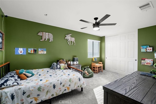 bedroom with ceiling fan, carpet flooring, and a closet