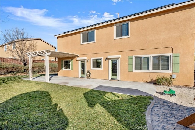 back of house with a lawn, a pergola, and a patio area