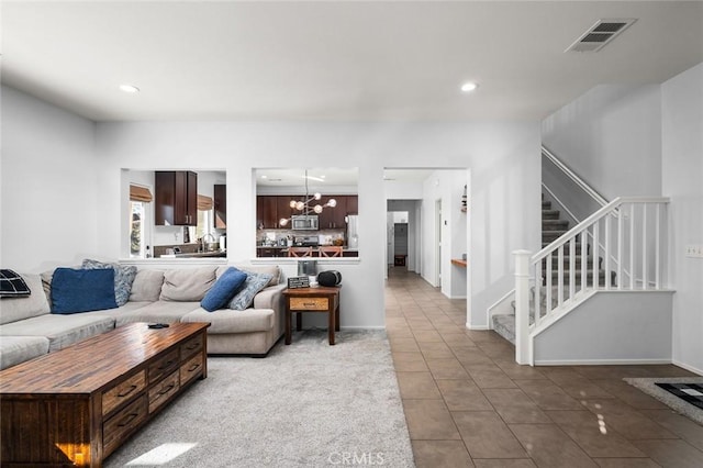 tiled living room featuring a notable chandelier