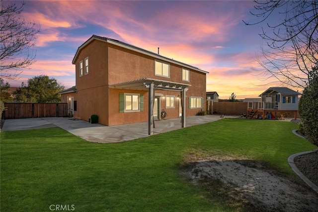 back house at dusk featuring a playground, a pergola, a patio area, and a yard