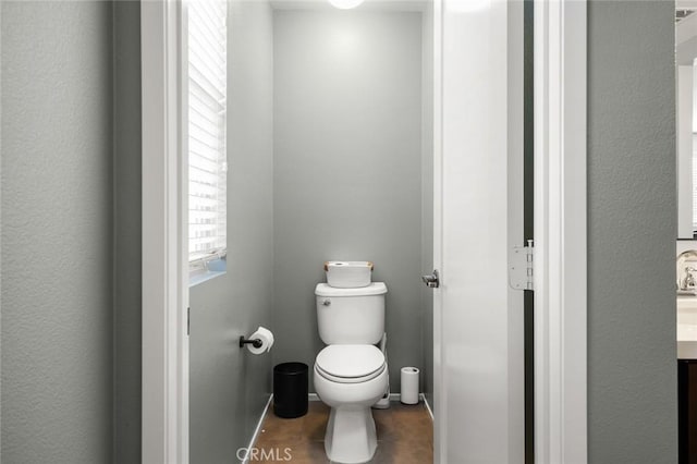 bathroom featuring toilet and vanity