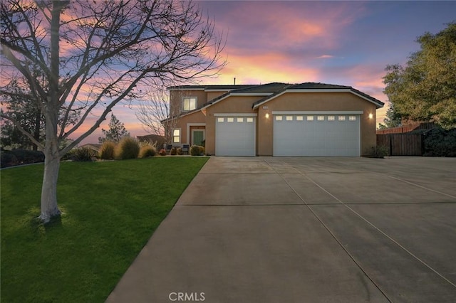 view of front of home featuring a garage and a lawn