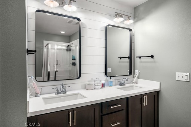 bathroom featuring vanity and a shower with door