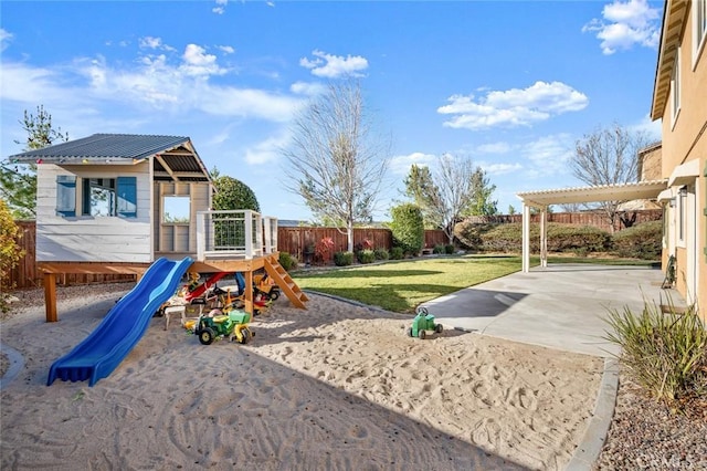 view of playground with a lawn and a patio area