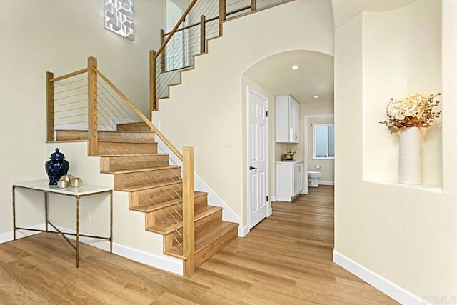 staircase featuring wood-type flooring