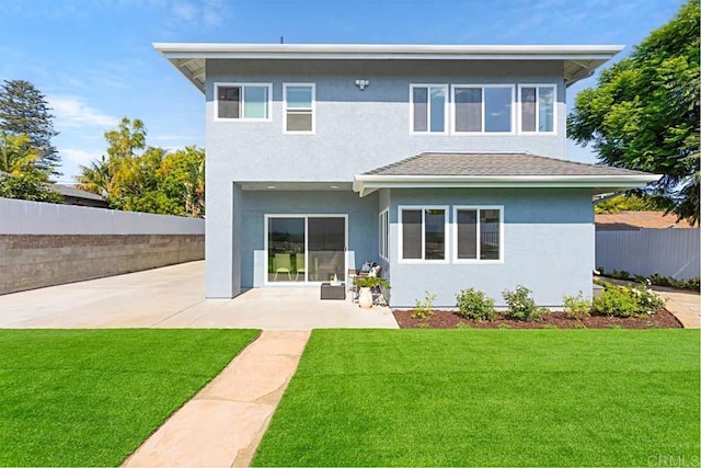 rear view of property with a patio area and a lawn