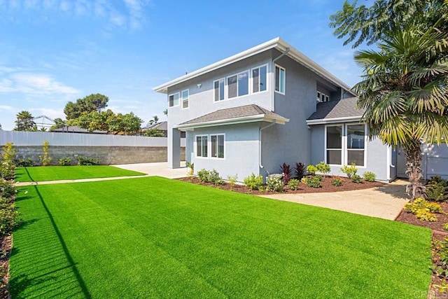 back of house featuring a yard