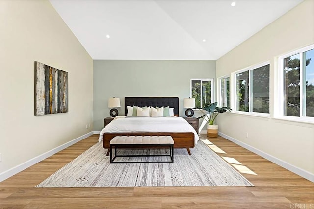 bedroom featuring light hardwood / wood-style flooring and lofted ceiling