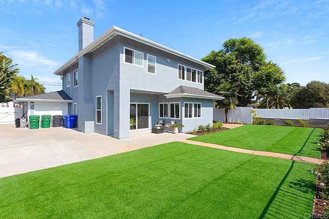 back of house with a yard and a patio area