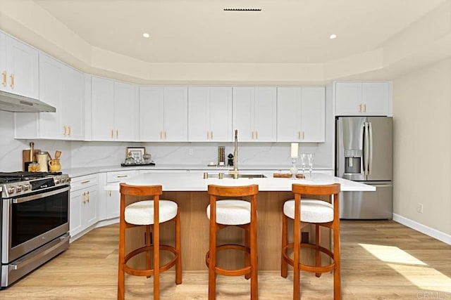 kitchen featuring white cabinetry, an island with sink, and appliances with stainless steel finishes