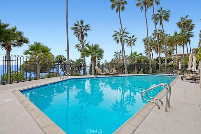 pool featuring a patio and fence