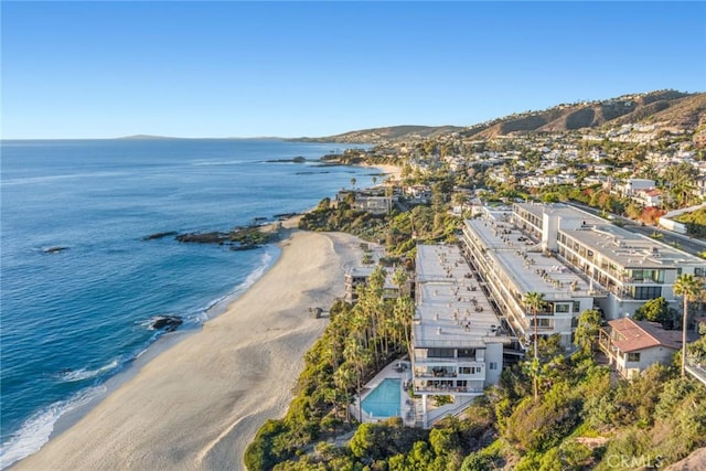 drone / aerial view with a beach view and a water view