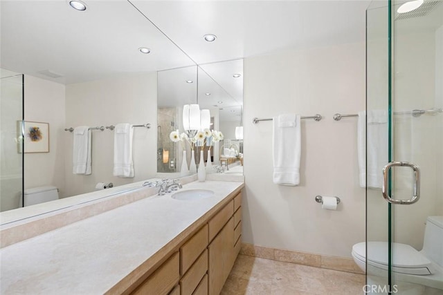 bathroom with recessed lighting, toilet, a shower with shower door, vanity, and tile patterned flooring