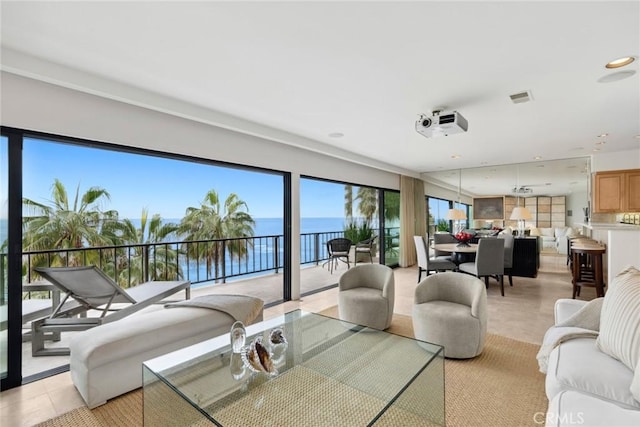 living room with a water view, visible vents, and recessed lighting