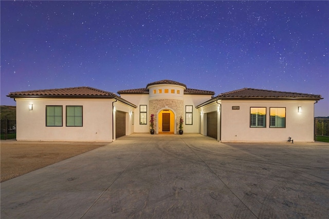 mediterranean / spanish-style home featuring a garage