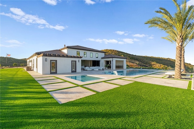 back of house featuring a yard and a patio