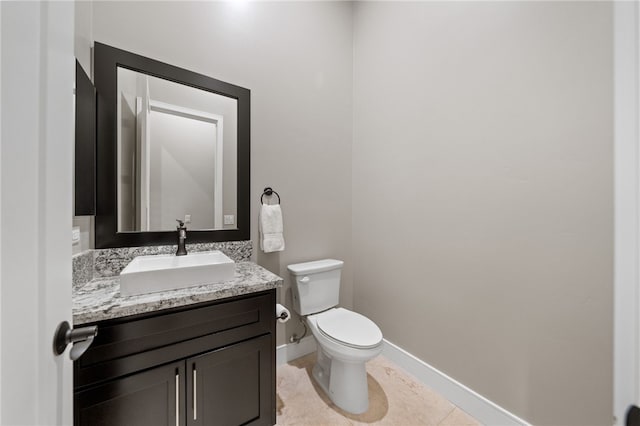 bathroom with tile patterned floors, vanity, and toilet