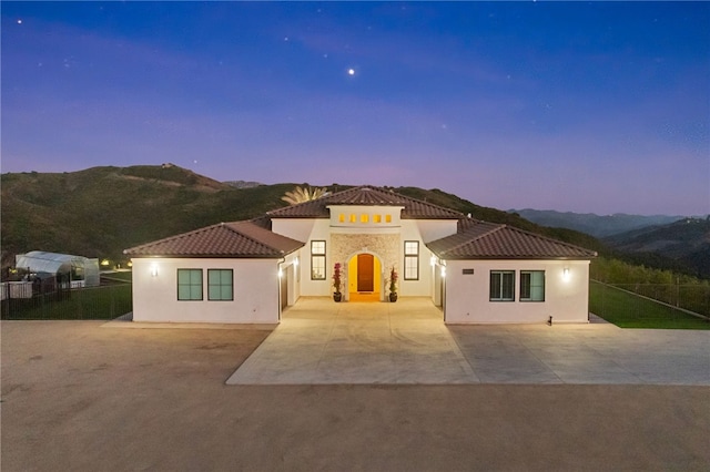 mediterranean / spanish house featuring a mountain view