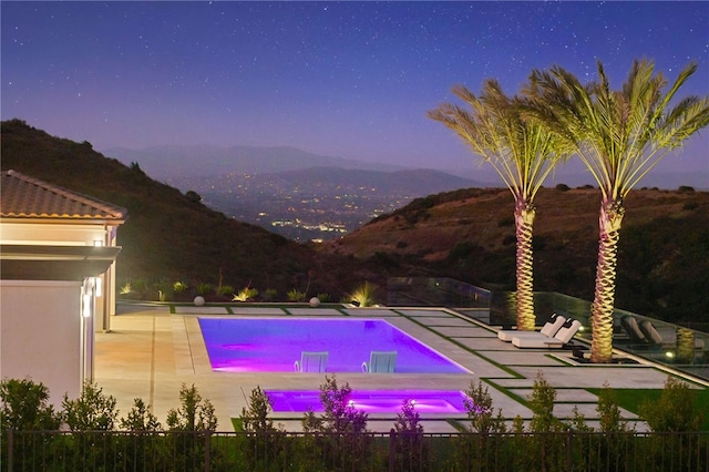 view of swimming pool with a mountain view and a patio