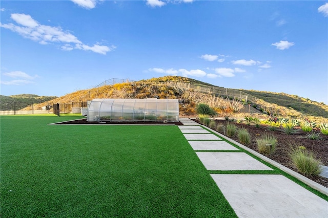 view of yard with a mountain view and an outdoor structure