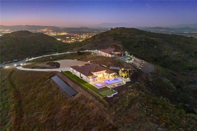 aerial view at dusk featuring a mountain view