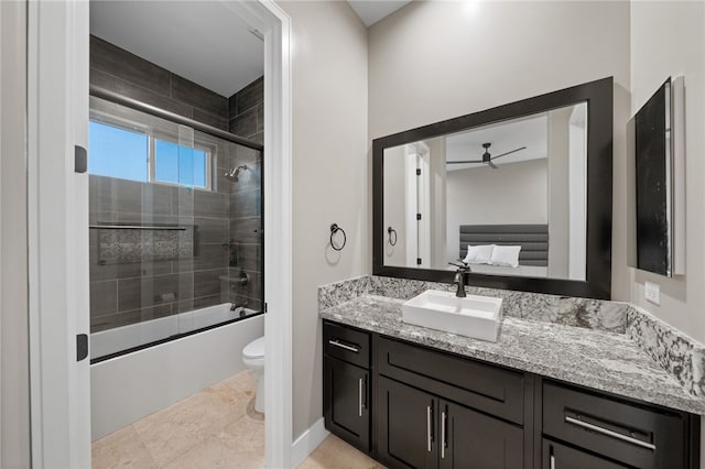 full bathroom with tile patterned floors, vanity, ceiling fan, shower / bath combination with glass door, and toilet