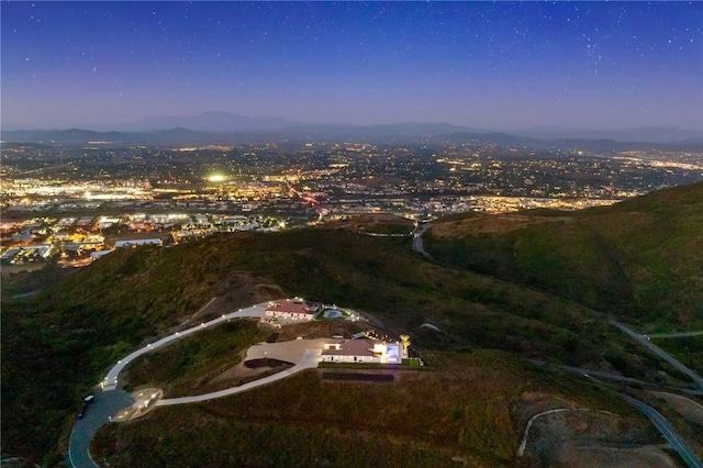 aerial view at dusk featuring a mountain view