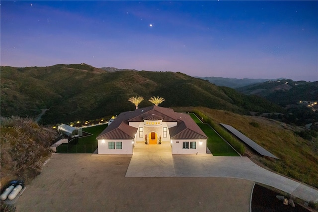 aerial view at dusk featuring a mountain view